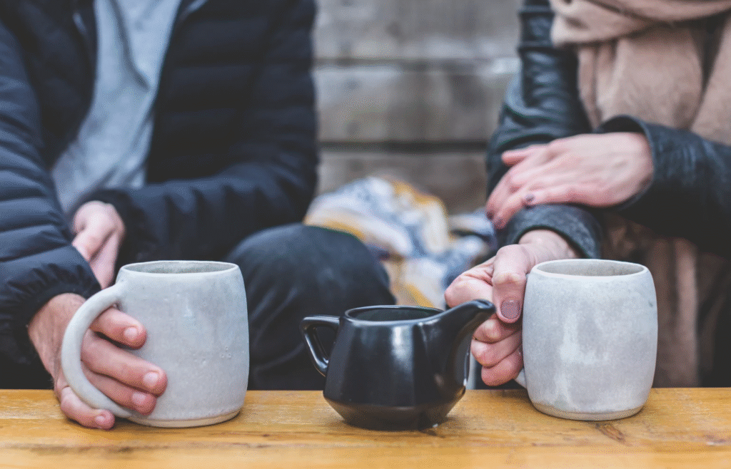 Questions freelancers should ask clients to avoid confusion. Image of a casual meeting over coffee. 